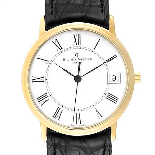 The image shows a front view of the Baume & Mercier Classima MV045077 Men's Yellow Gold White Dial MV045077 Men's Yellow Gold White Dial watch, highlighting its white dial, Roman numerals, and black leather strap.