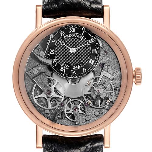 The Breguet Tradition 7057BR/G9/9W6 Men's Rose Gold Silver Dial 7057BR/G9/9W6 Men's Rose Gold Silver Dial watch is shown from the front, displaying its intricate open-worked dial and visible mechanical parts.
