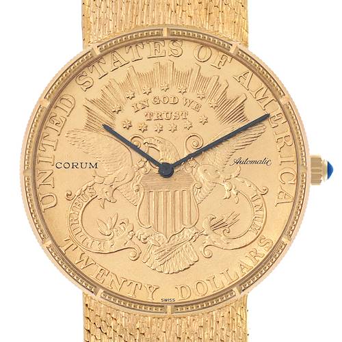 The Corum Coin Watch Men's Yellow Gold Black Dial model is shown from the front, highlighting the engraved dial and gold mesh band.