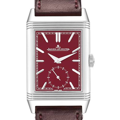 The Jaeger-LeCoultre Reverso watch is shown from a front angle, displaying its dial, case, crown, and part of the leather strap.