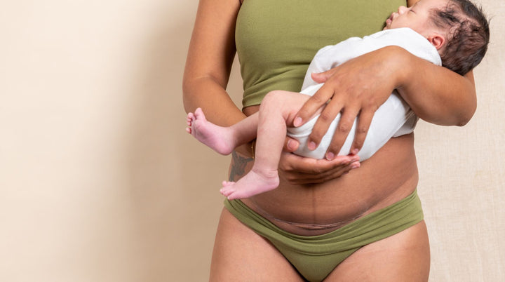 New mom holding baby while breastfeeding